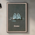 a framed poster of two shoes on a wall, with the word "tomorrow" written below the shoes.