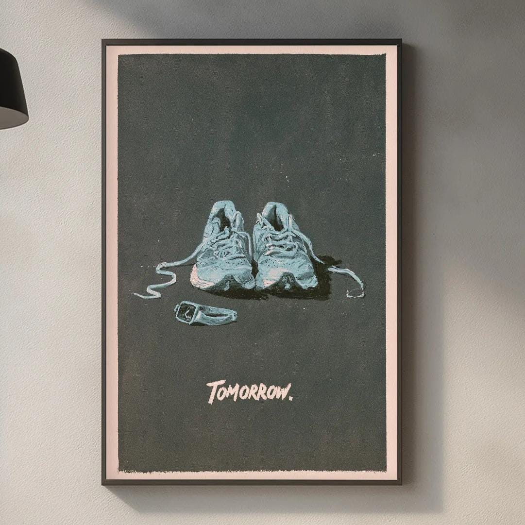 a framed poster of two shoes on a wall, with the word "tomorrow" written below the shoes.