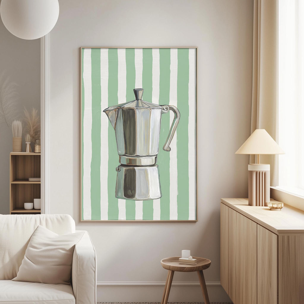 a living room with a white sofa, a wooden side table, and a framed picture of a silver coffee pot with green and white stripes on the wall.