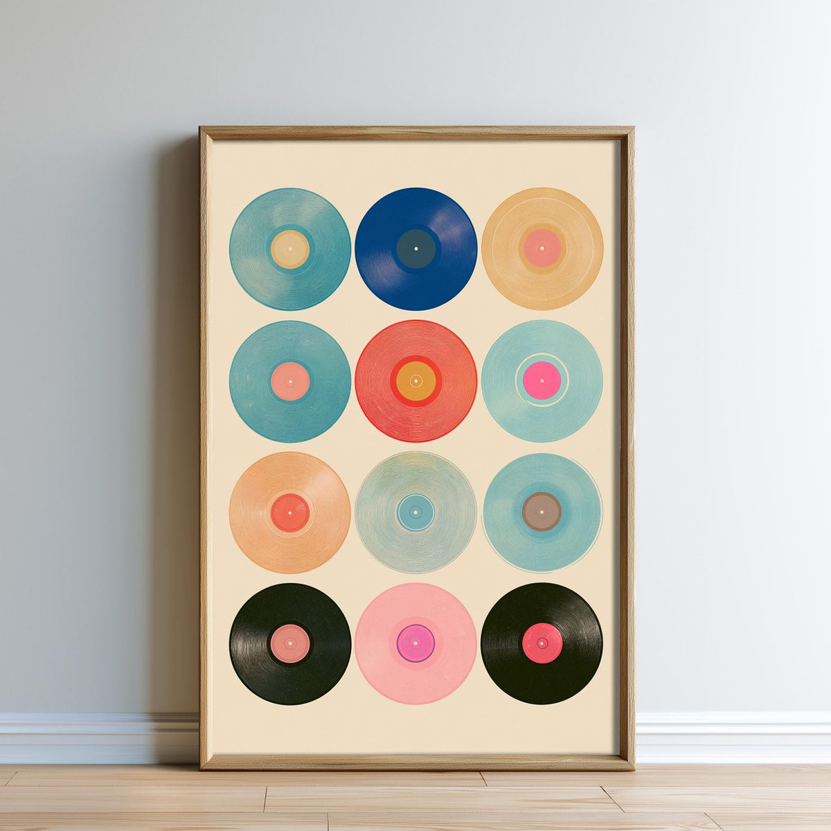 a framed collage of twelve circular records in various colors and designs, arranged in a grid pattern.