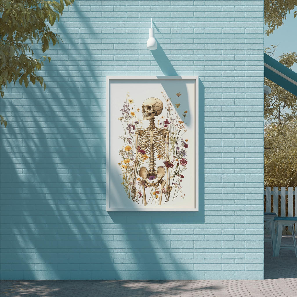a framed artwork of a skeleton surrounded by flowers and plants, mounted on a blue brick wall.