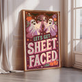 A framed poster with a Halloween-themed design, featuring two ghostly figures and a disco ball, along with the text "Let's Get Sheetfaced".
