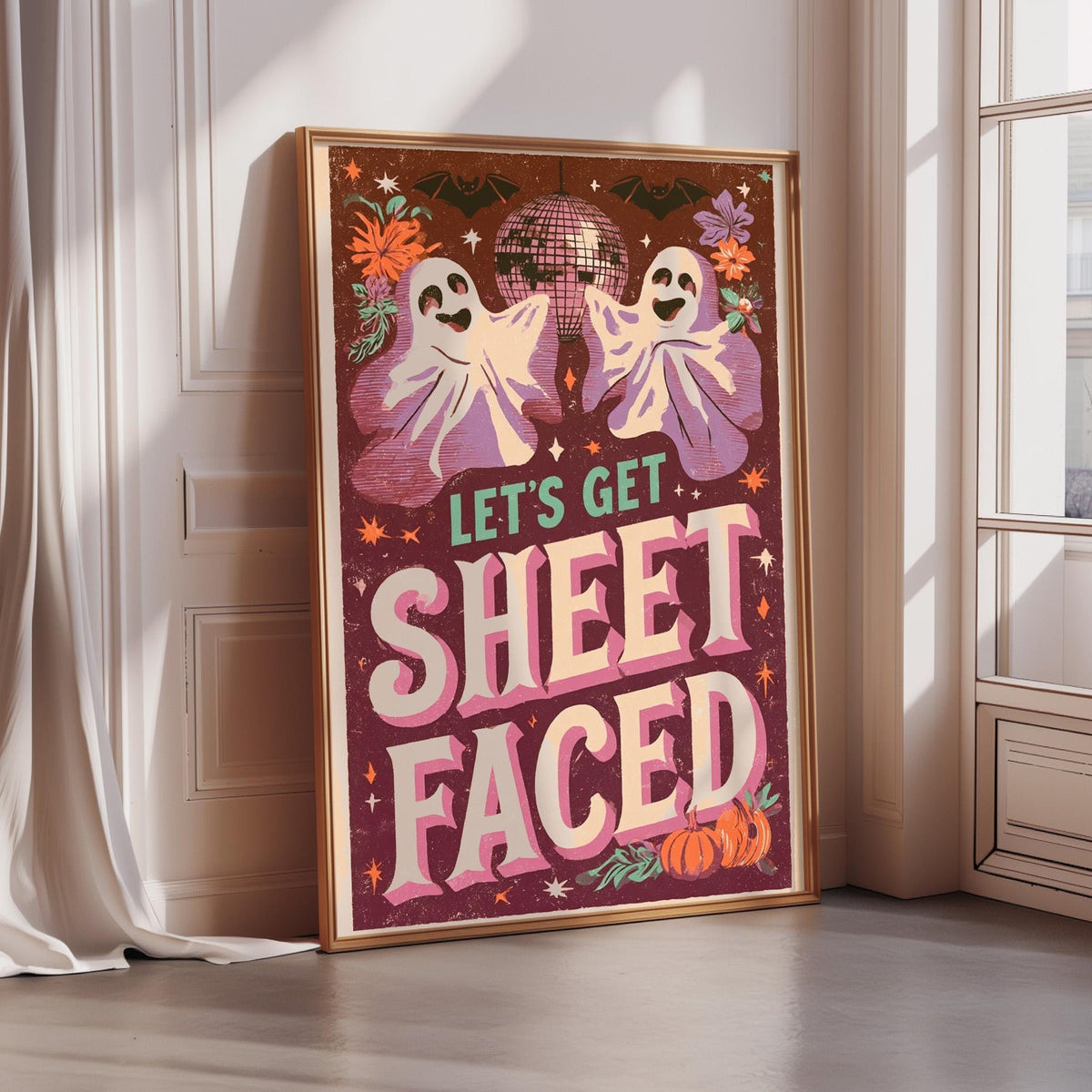 A framed poster with a Halloween-themed design, featuring two ghostly figures and a disco ball, along with the text "Let's Get Sheetfaced".