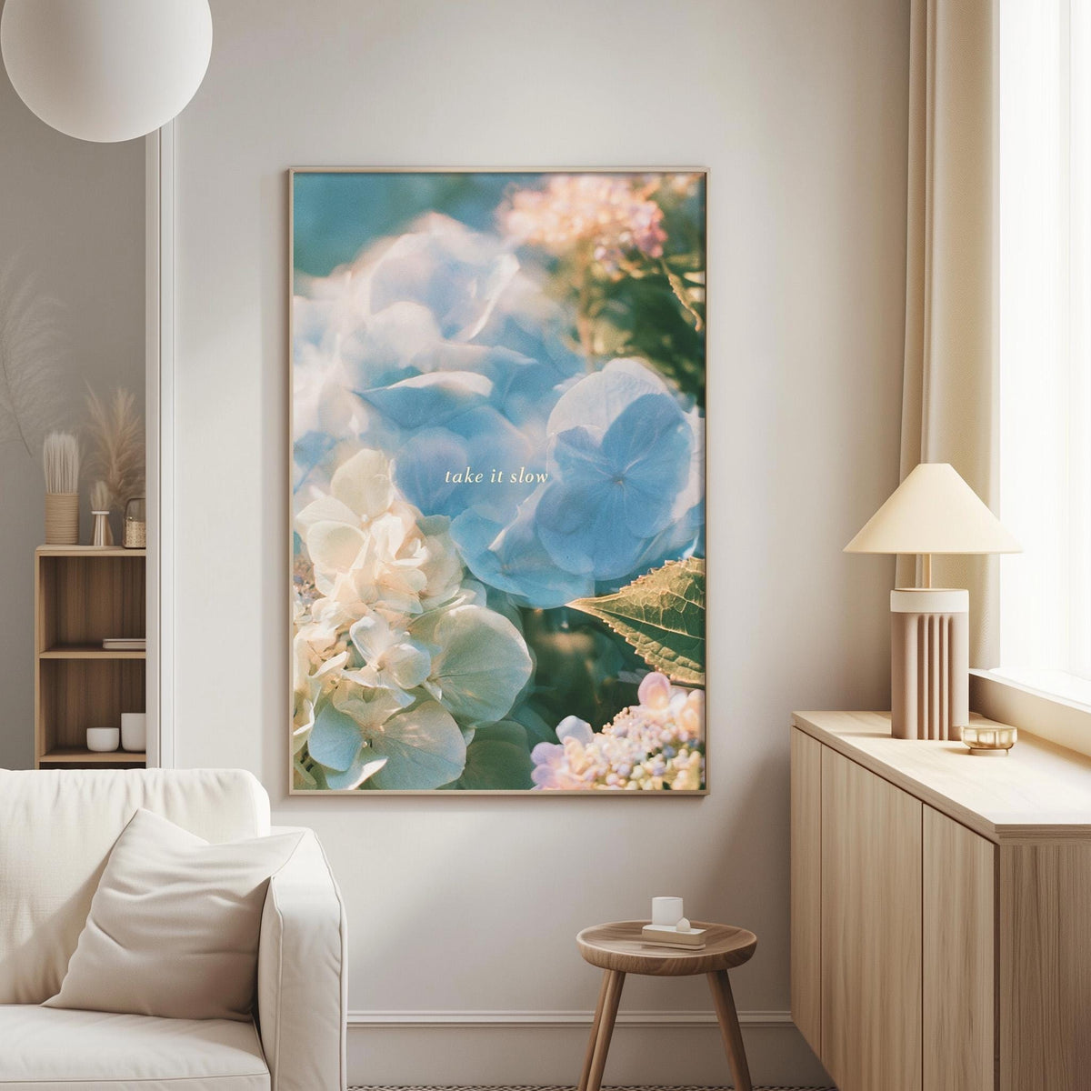 a large framed picture of flowers hanging on a wall in a living room.