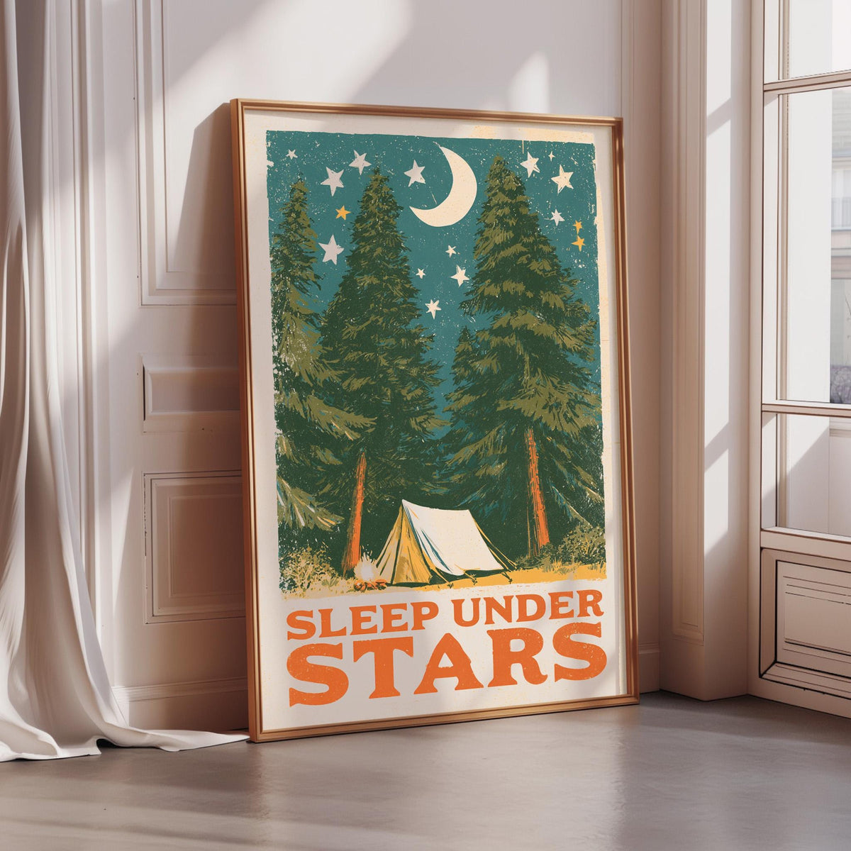 A framed poster with a nighttime scene of pine trees and a tent, along with the text "SLEEP UNDER STARS" in the bottom right corner.