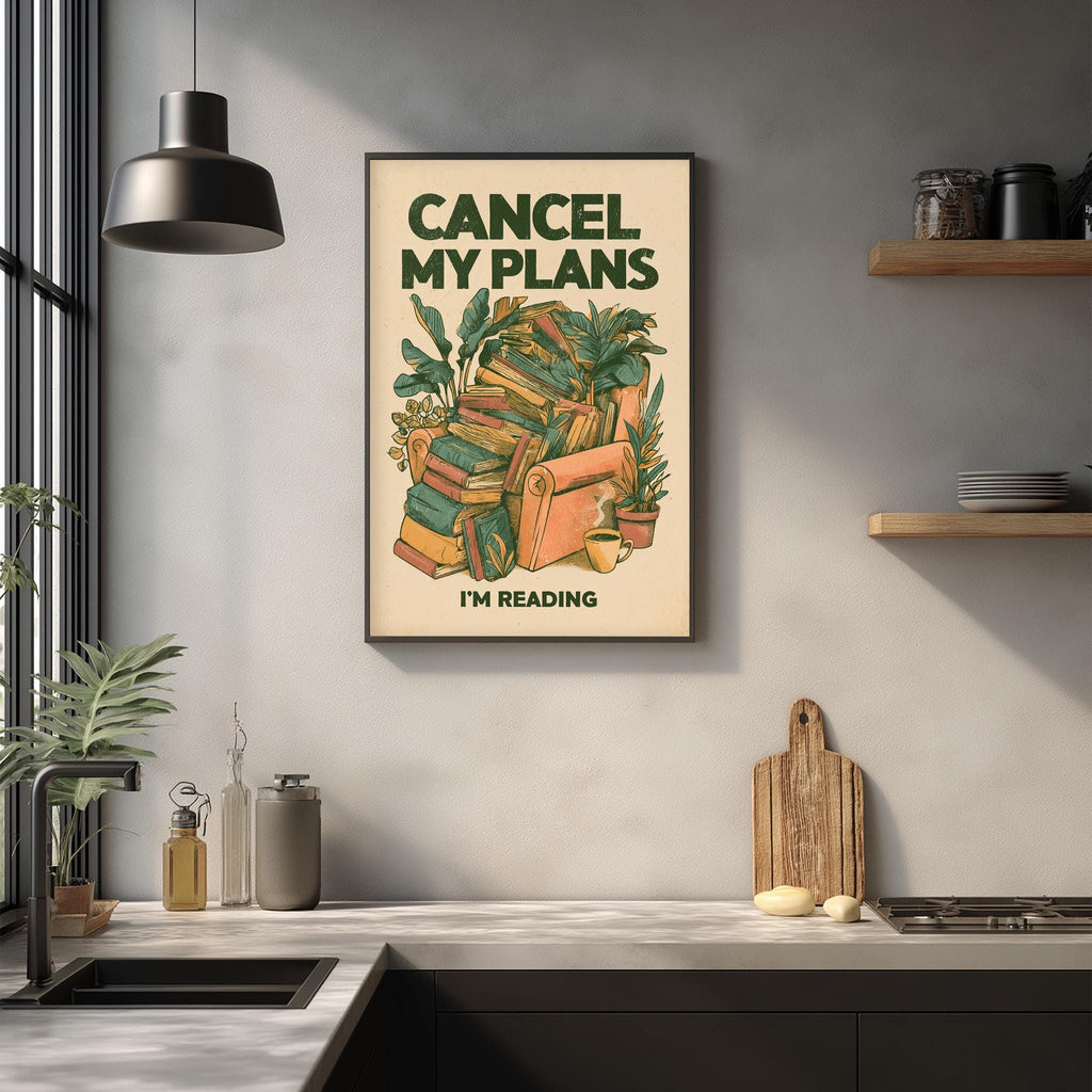 a framed poster with the text "CANCEL MY PLAN'S I'M READING" hanging on a wall above a kitchen counter.