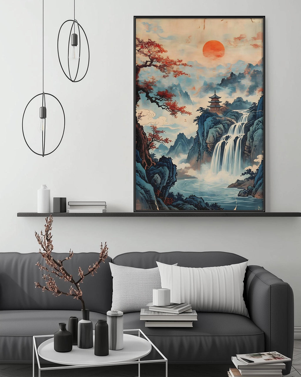 a large, colorful painting of a serene landscape with a waterfall, mountains, and a temple, hanging on a wall above a gray couch with white pillows. The painting is surrounded by various decorative items, such as a potted plant, vases, and books, creating a cozy and inviting atmosphere in the living room.