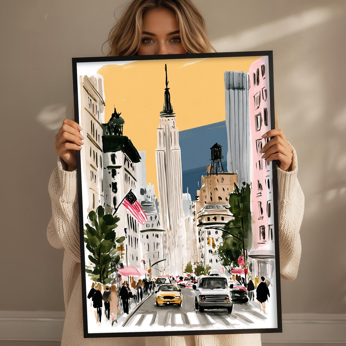 A woman holds up a framed painting depicting a busy city street scene with tall buildings, cars, and pedestrians.