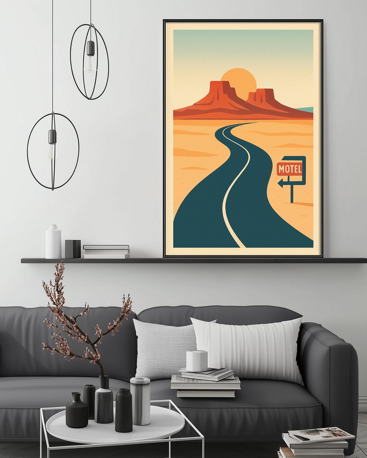 a modern living room with a gray sofa, a coffee table, and a framed poster of a desert landscape with a winding road and a motel sign.