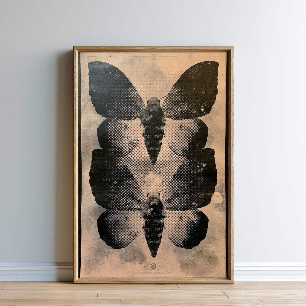 The image is a framed print featuring a striking black and white image of two butterflies. The butterflies are positioned in a way that they appear to be facing each other, creating a sense of symmetry and balance in the composition. The print is displayed on a wall, and the overall color scheme is predominantly black and white, with some subtle variations in the background.