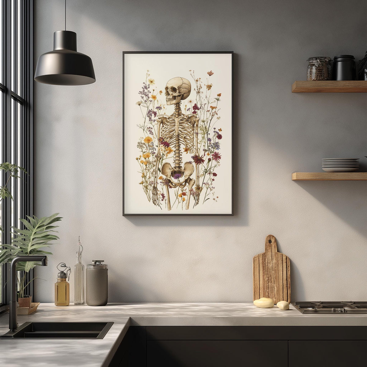 a kitchen counter with various items, including a framed skeleton drawing, a wooden cutting board, and a potted plant.