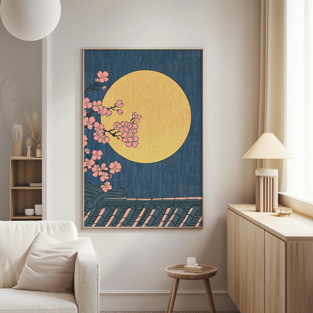 a living room with a large framed artwork hanging on the wall, depicting a night scene with a full moon and pink cherry blossoms.
