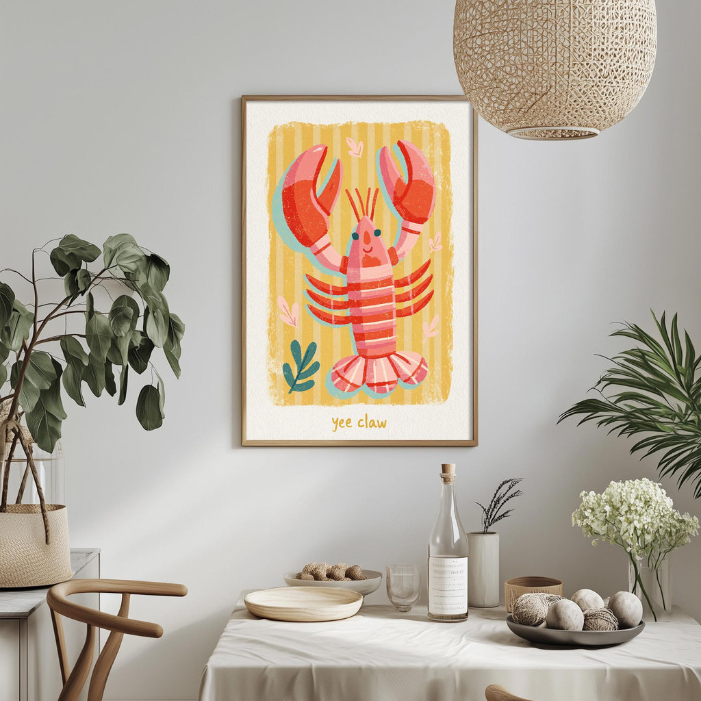 a framed illustration of a lobster on a wall, with a dining table and chairs in the foreground.