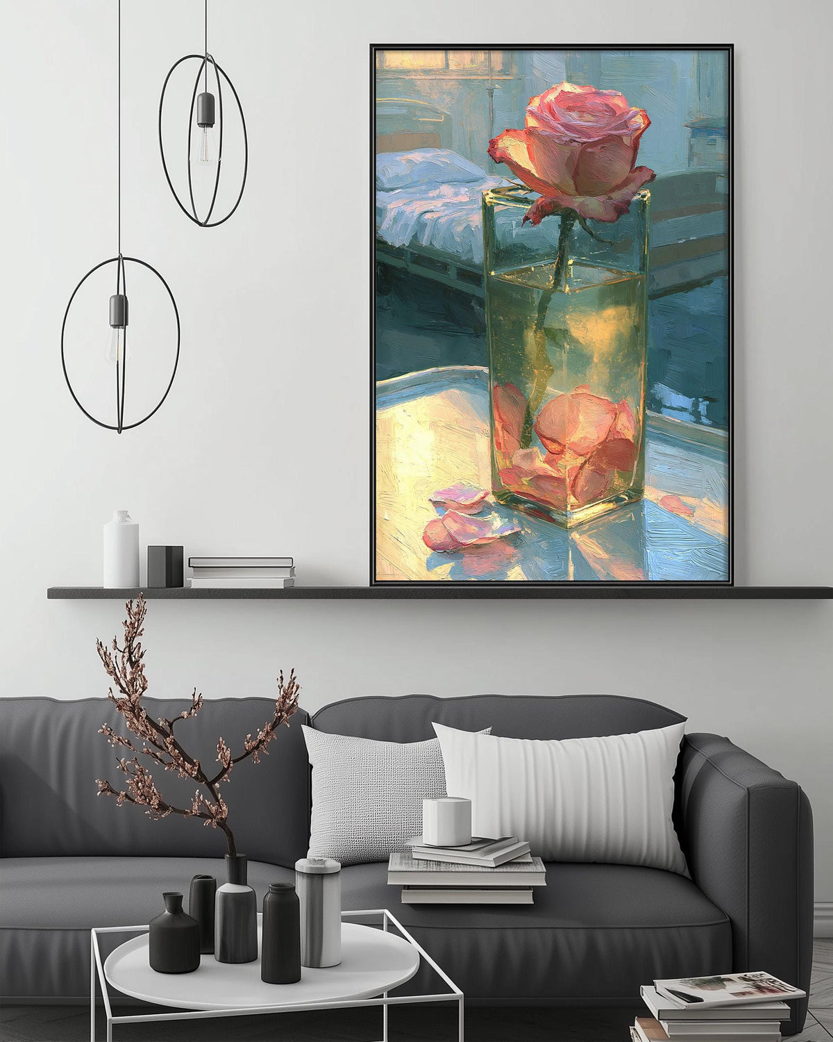 a large painting of a pink rose in a glass vase, hanging on a wall above a gray couch with a white pillow. The painting is surrounded by various decorative items, including a potted plant, a coffee table, and a bookshelf.