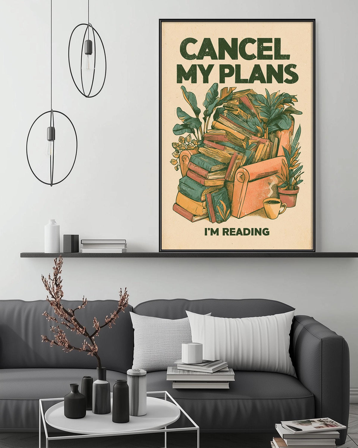 a cozy living room with a gray couch, a coffee table, and a framed poster on the wall that reads "CANCEL MY PLANES I'M READING".