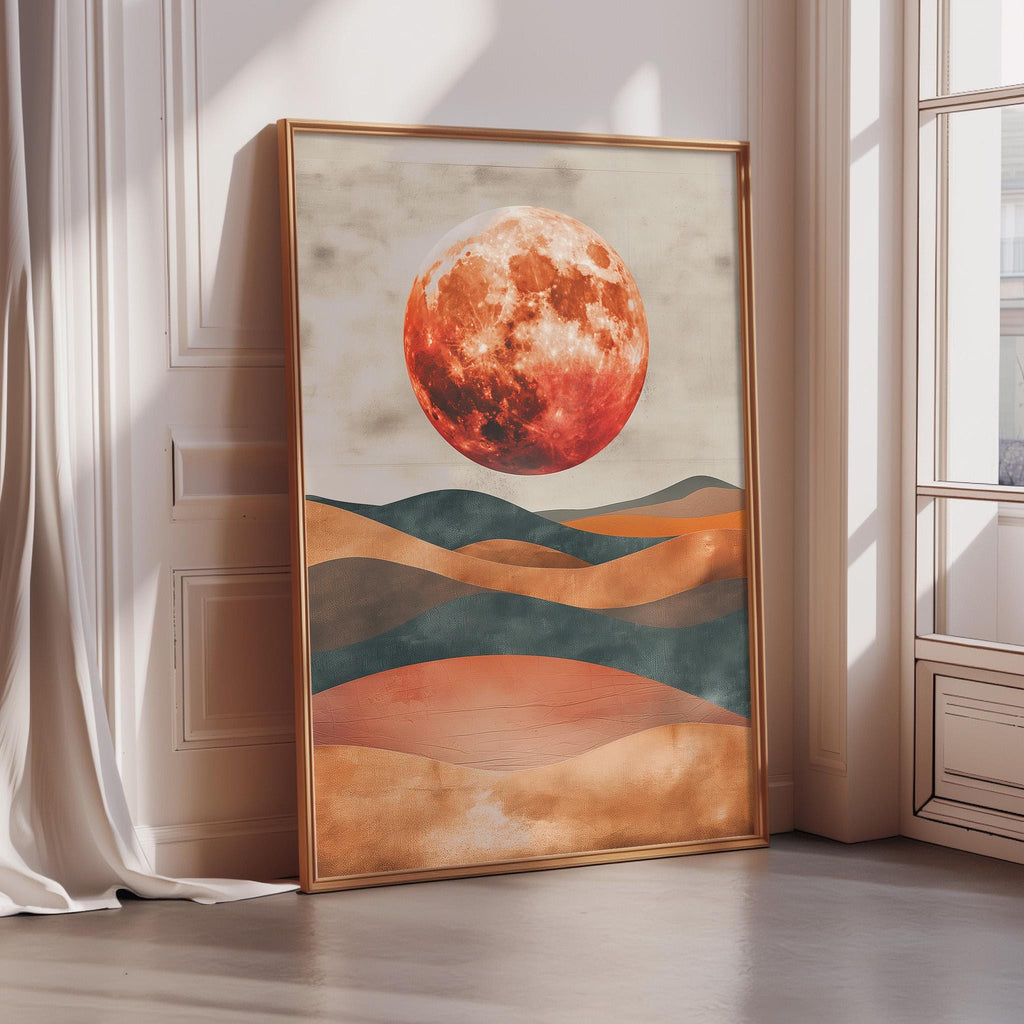 a large framed painting depicting a red moon over a landscape with hills and mountains.