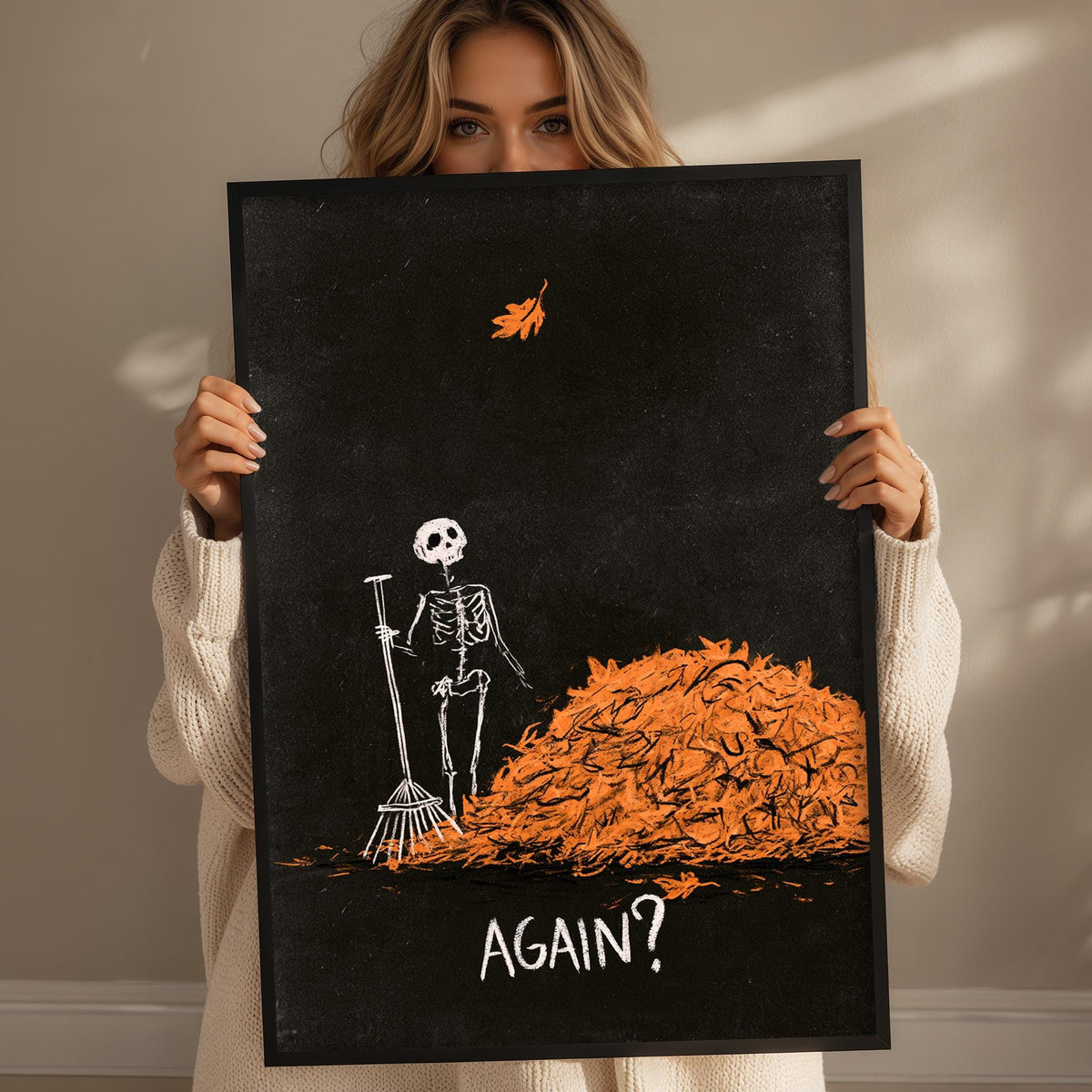A woman holding a framed poster with a skeleton and a pile of orange leaves, with the word "AGAIN?" written below the poster.