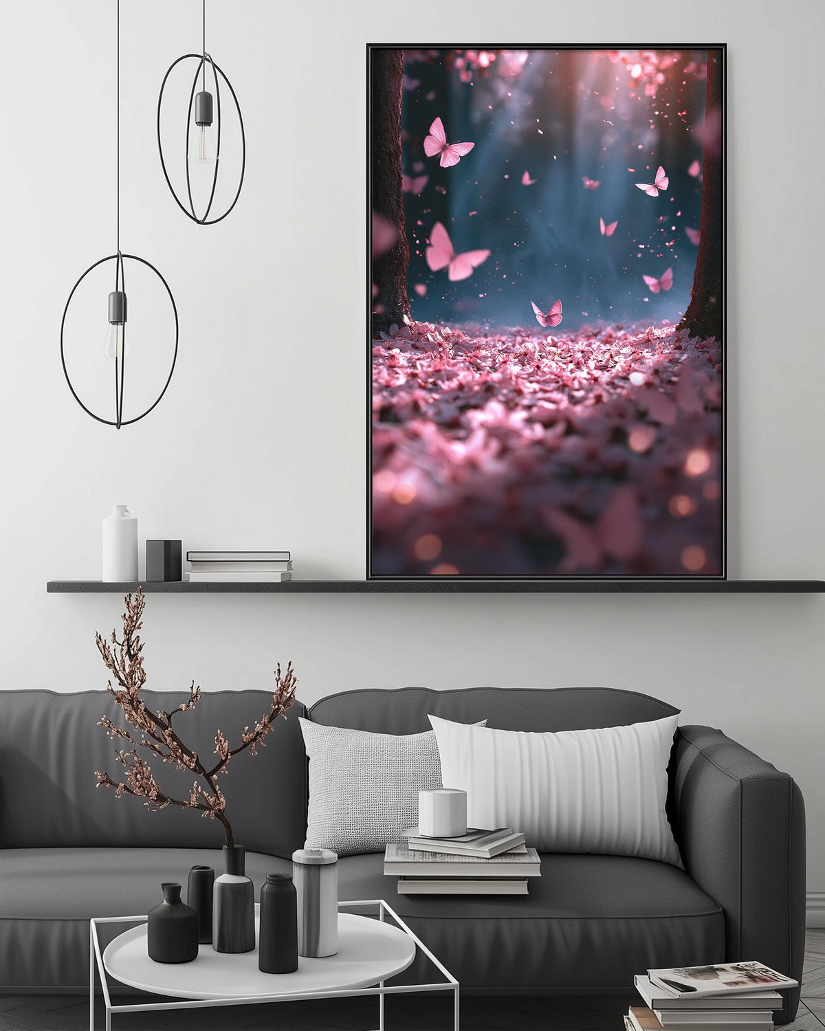 a large framed picture of pink flowers and butterflies hanging on a wall above a gray couch in a living room setting.