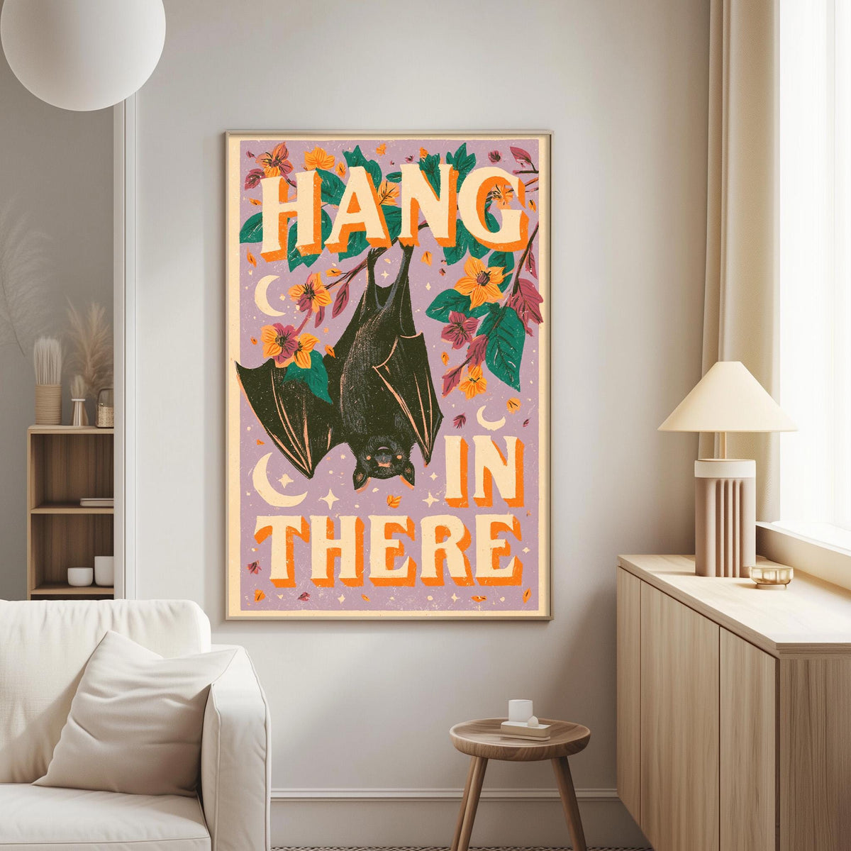 a poster with a bat and flowers hanging on a wall in a living room.
