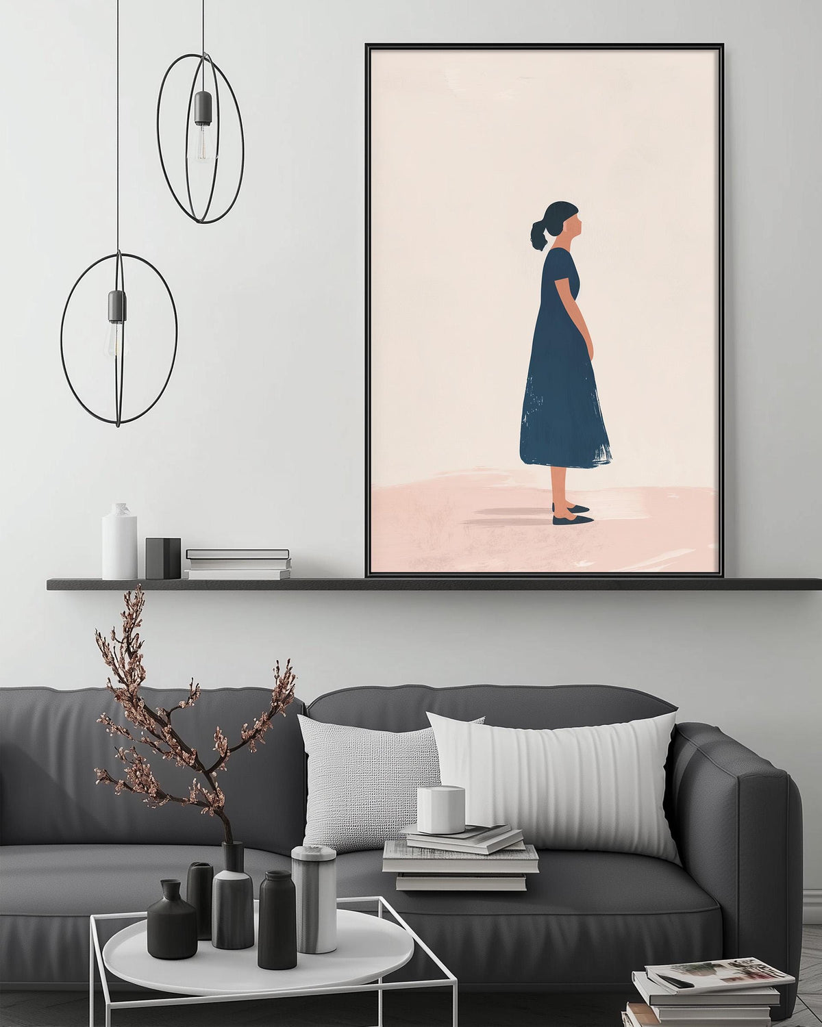 a modern living room with a gray sofa, a coffee table, and a framed artwork of a woman in a blue dress. The artwork is hanging on the wall above the sofa, and the room has a minimalist and stylish design with circular pendant lights, a shelf with decorative items, and a stack of books on the coffee table.
