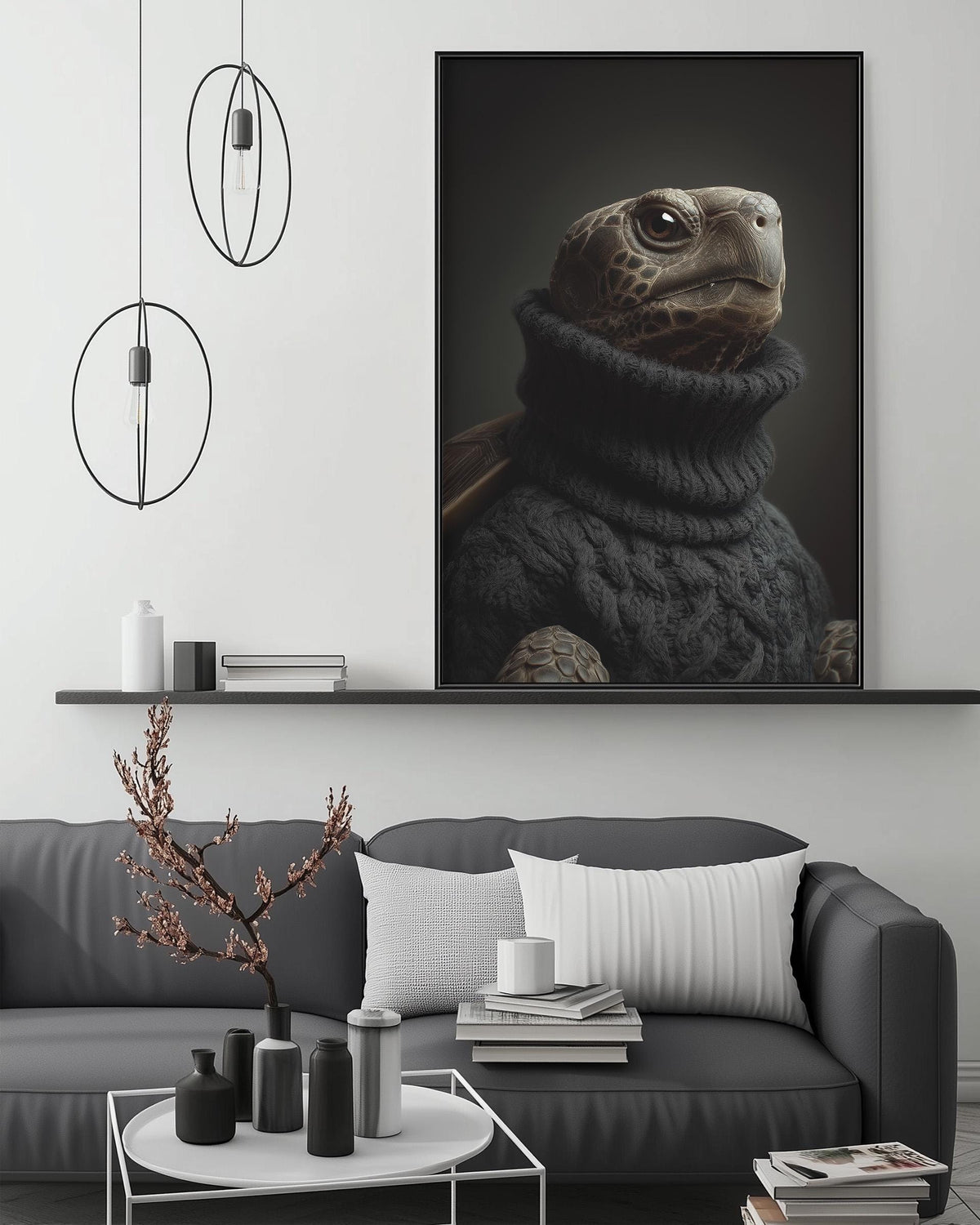 a large black and white photograph of a turtle wearing a sweater, displayed on a wall above a gray couch with a coffee table in front of it.