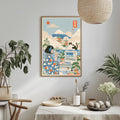 a framed illustration of a woman in a floral dress, surrounded by various objects such as a cat, a television, and a potted plant, all set against a backdrop of a mountain and a clear blue sky.