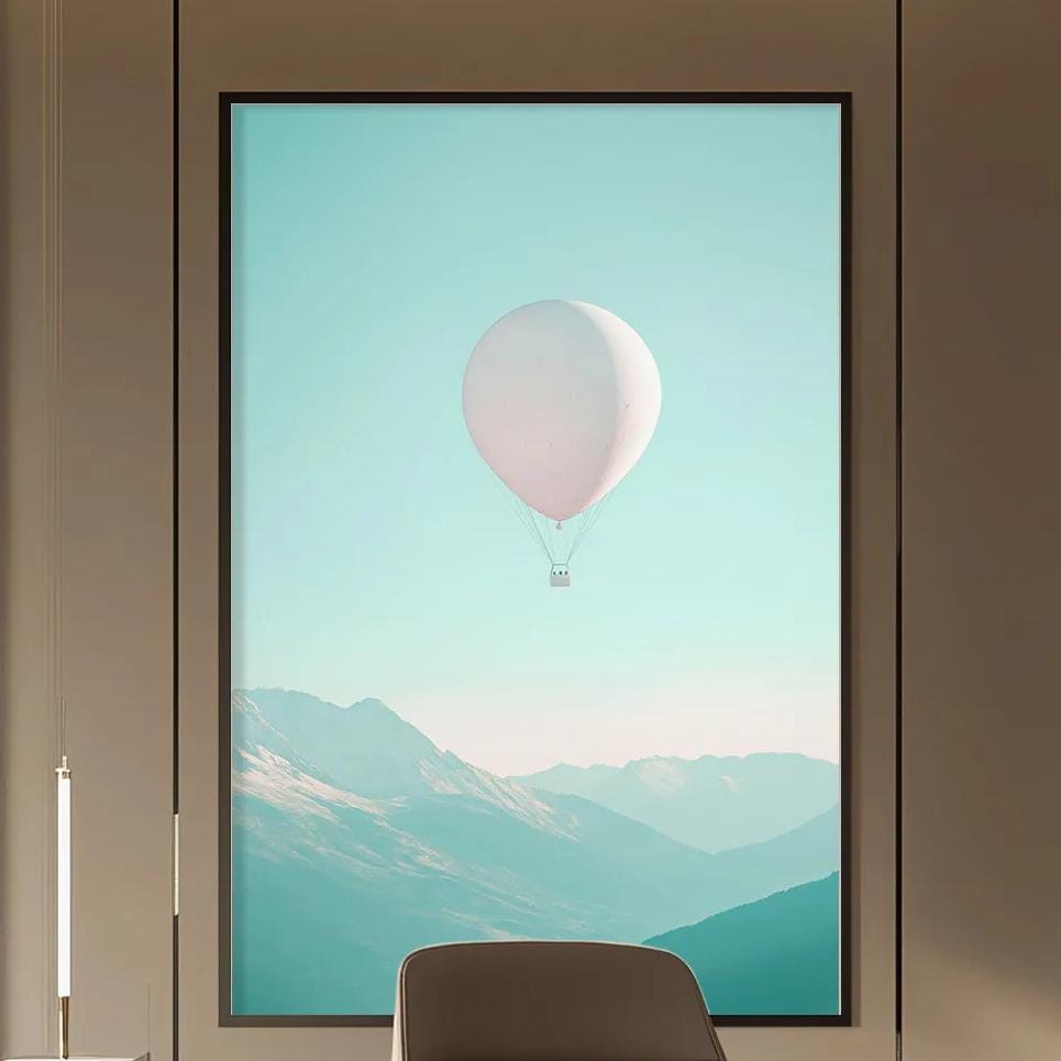 a modern and minimalist office space with a large window that offers a view of mountains and a hot air balloon in the sky. The office features a wooden desk, a comfortable-looking chair, and a bookshelf filled with books. The overall design and decor create a serene and inspiring atmosphere.
