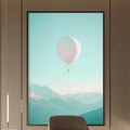 a modern and minimalist office space with a large window that offers a view of mountains and a hot air balloon in the sky. The office features a wooden desk, a comfortable-looking chair, and a bookshelf filled with books. The overall design and decor create a serene and inspiring atmosphere.