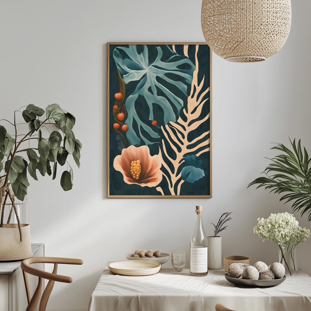 a dining table with a white tablecloth, a bowl of fruit, a bottle, and a vase with flowers. Above the table, there is a framed painting of a tropical plant with a pink flower and green leaves.