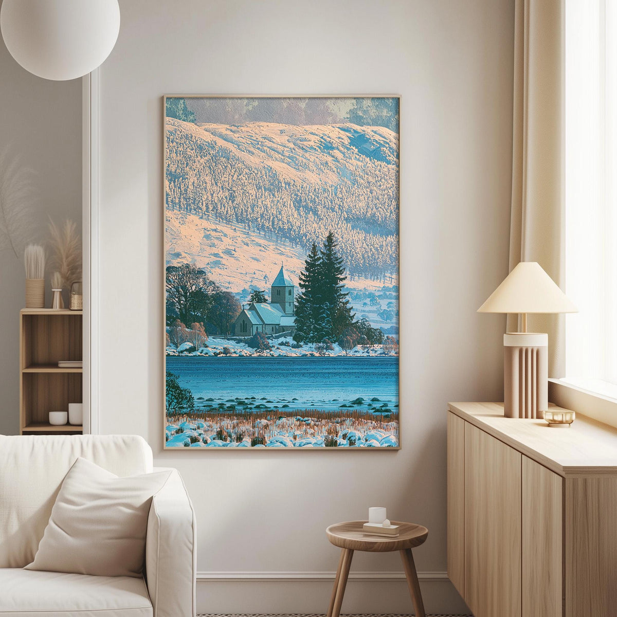 a large framed picture of a snowy landscape with a church in the background, hanging on a wall in a living room.