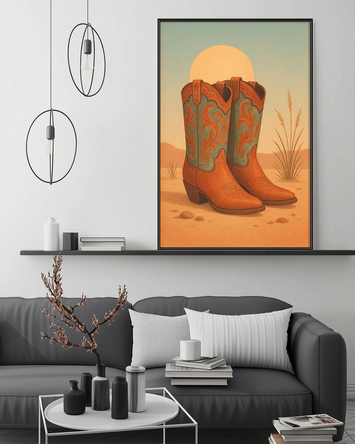 a cozy living room with a gray couch, a coffee table, and a framed artwork of cowboy boots on the wall above it.