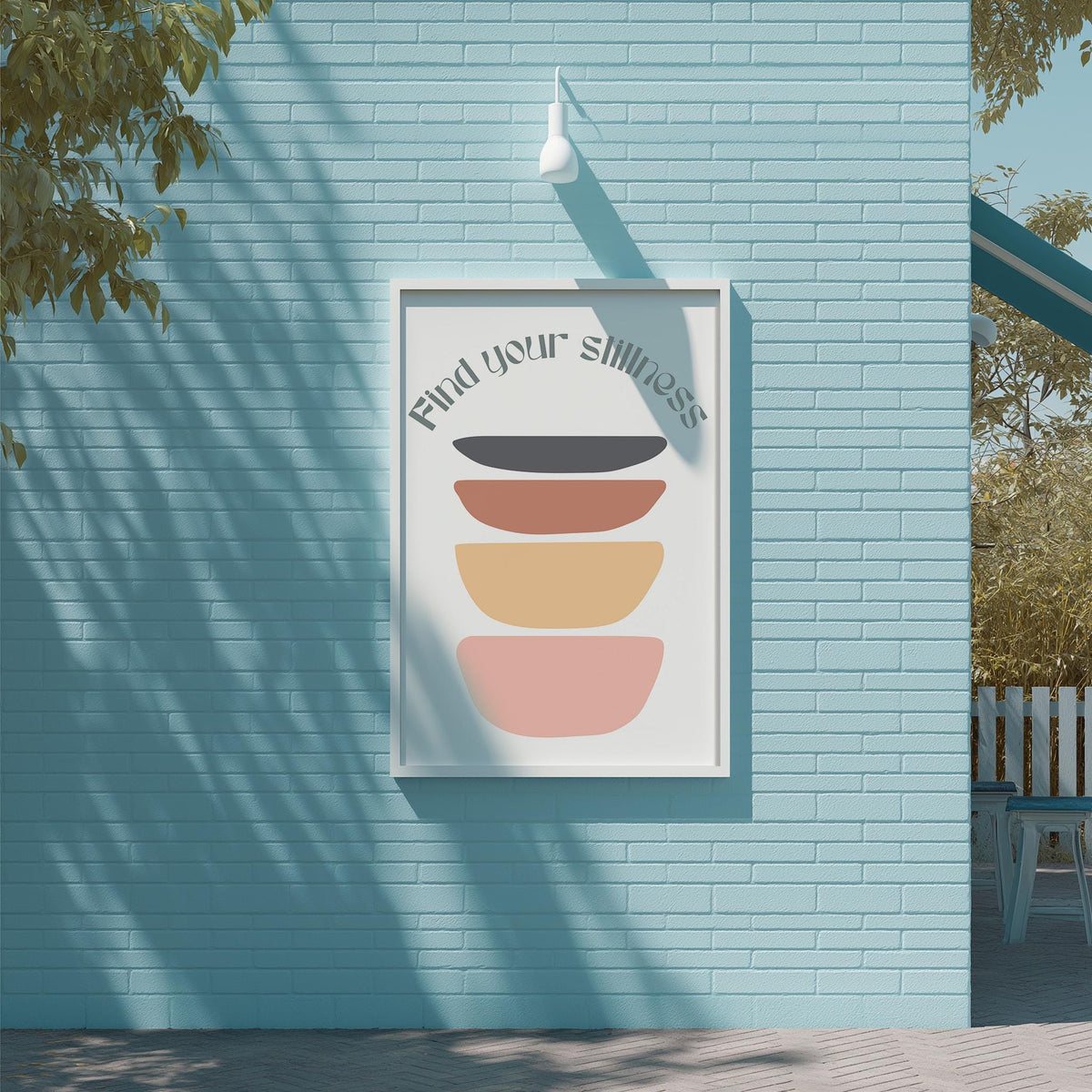 a blue brick wall with a framed poster hanging on it. The poster has a colorful design with a message that reads "Find your silliness".