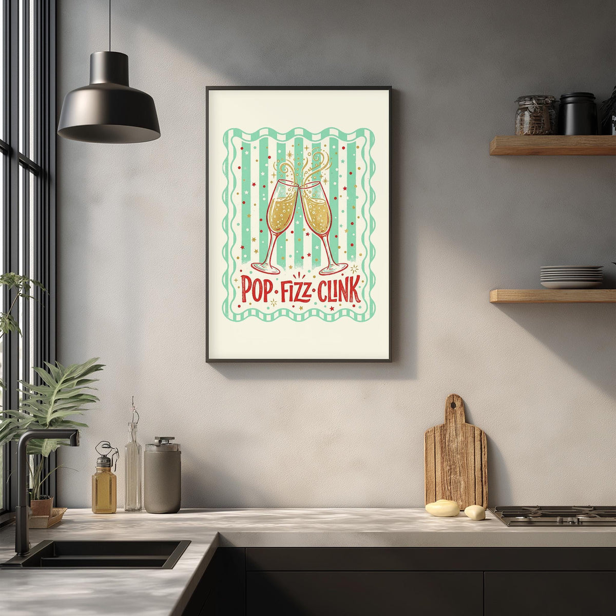 a framed poster with a design of two champagne glasses and the text "POP-FIZZ-CLINK" hanging on a wall above a kitchen counter.