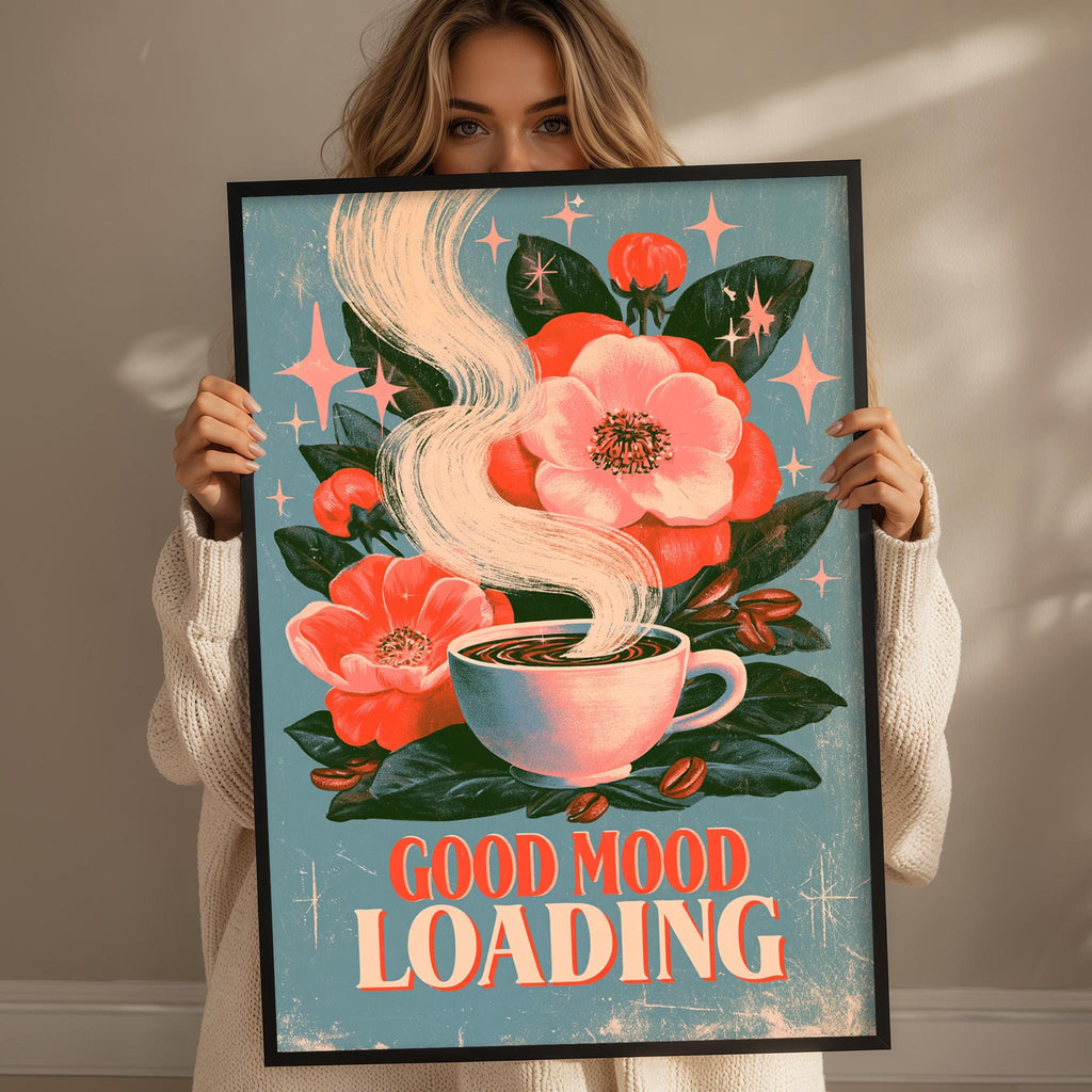 A woman holding a framed poster with a floral design and a cup of coffee.