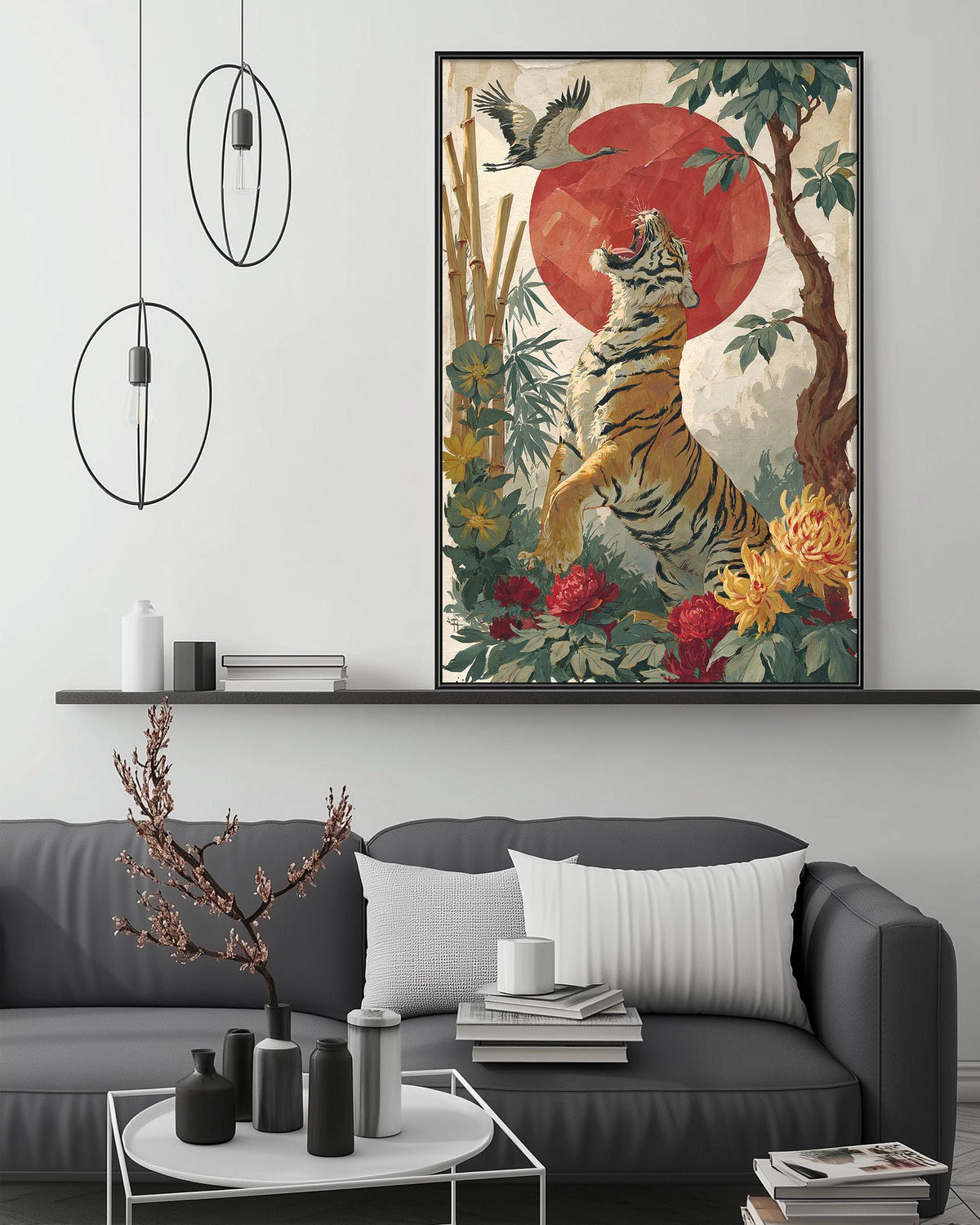 a large framed painting of a tiger in a lush, colorful jungle setting, with a red sun in the background. The painting is hanging on a wall above a gray couch, which has a coffee table in front of it. The room also includes a shelf with various decorative items, such as a potted plant, vases, and books.