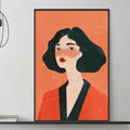 a modern living room with a gray sofa, a coffee table, and a large framed illustration of a woman in an orange outfit. The room has a minimalist and stylish design, with a black and white color scheme and a few decorative elements such as a potted plant and a stack of books.