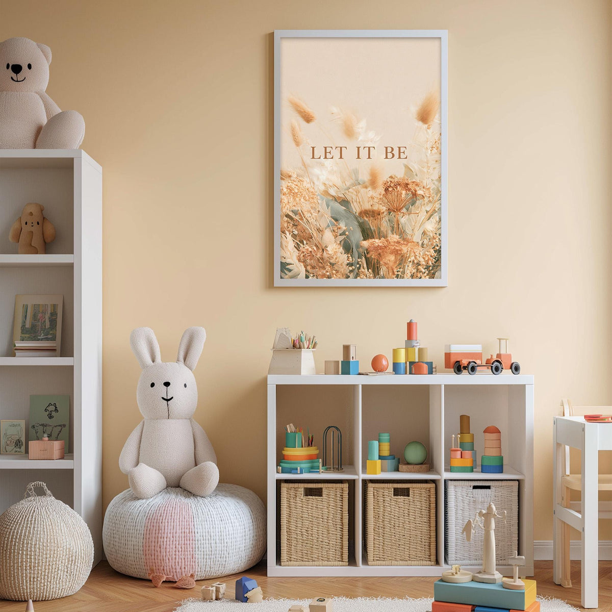 A cozy and colorful children's bedroom with a large stuffed bunny, a bookshelf, and a toy storage unit. The walls are painted a light peach color, and there is a framed poster with the text "LET IT BE" above the bookshelf.
