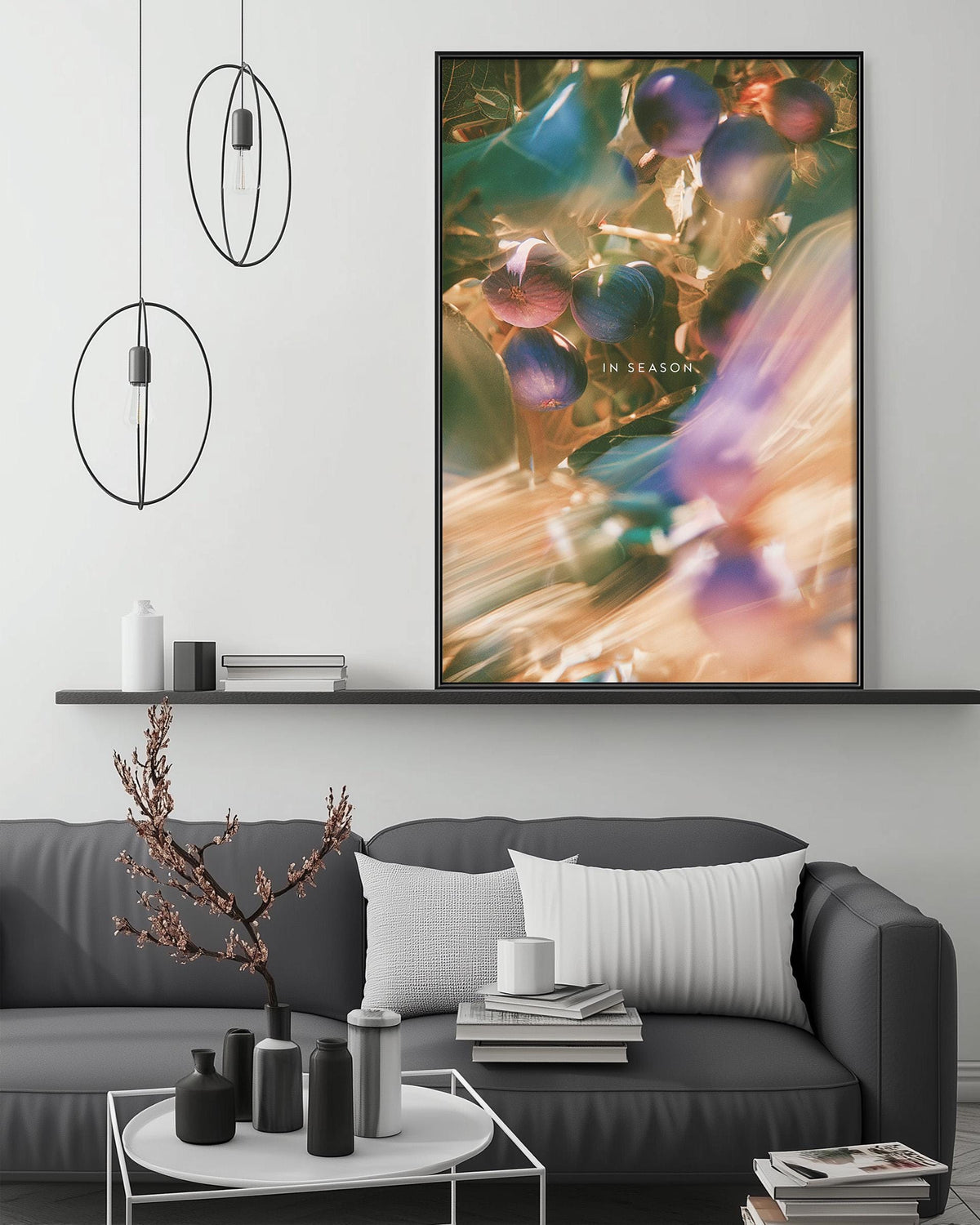 a modern living room with a gray sofa, a coffee table, and a large abstract painting hanging on the wall above the sofa.