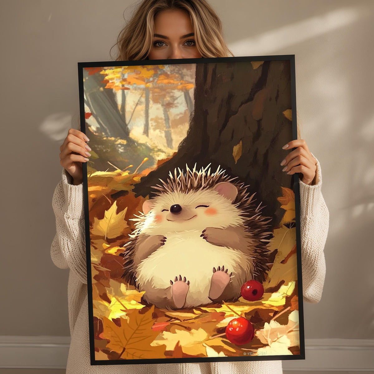 A woman holds up a framed painting depicting a hedgehog surrounded by autumn leaves and a red apple.