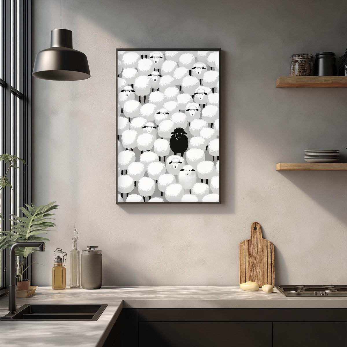 a kitchen counter with various kitchen items, including a cutting board, a bottle, and a bowl. Above the counter, there is a framed artwork depicting a group of sheep with a single black sheep standing out from the rest.