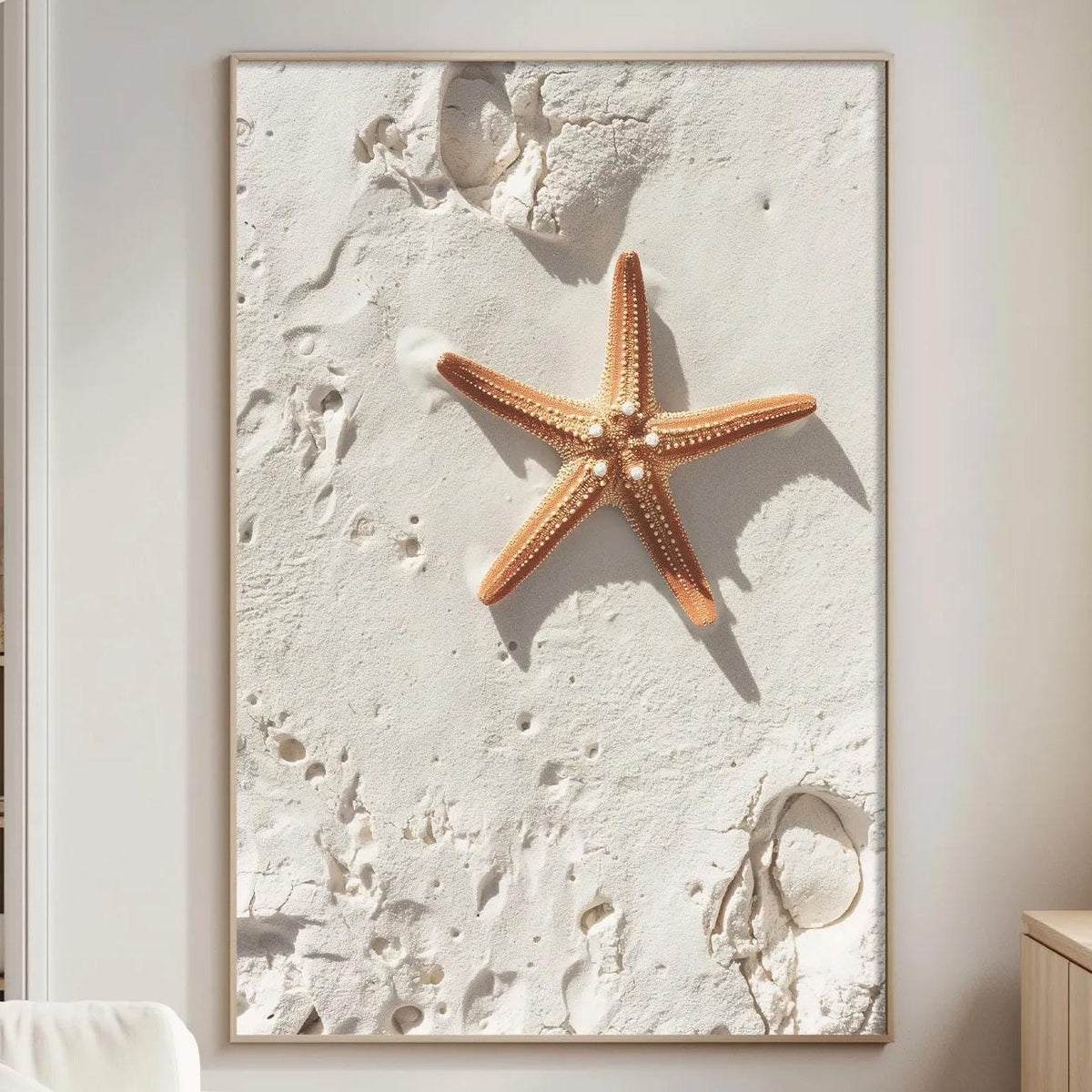 a large framed picture of a starfish on a wall in a living room.