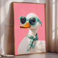 A framed illustration of a duck wearing sunglasses and a scarf is displayed on a wall.
