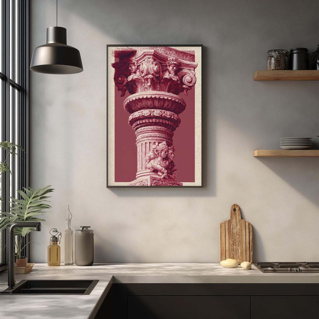 a kitchen counter with a framed photograph of a decorative column hanging above it. The photograph is in a pinkish-red color and appears to be a close-up of the column's intricate details. The kitchen counter also has various items such as a cutting board, a bottle, and a vase.