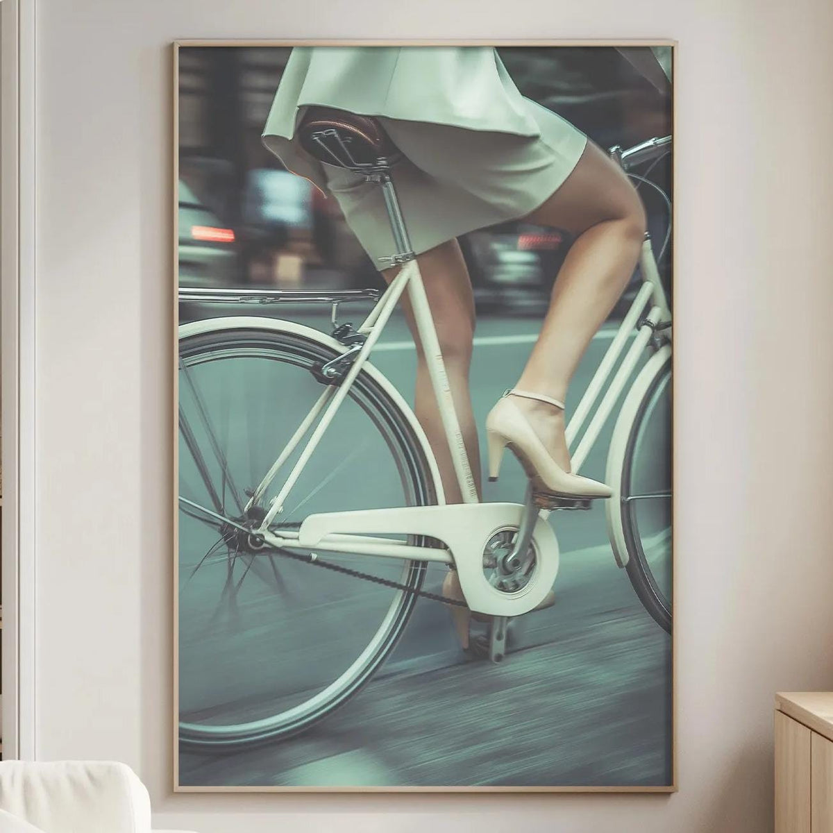 a woman riding a bicycle, with a focus on her legs and the bicycle's frame.
