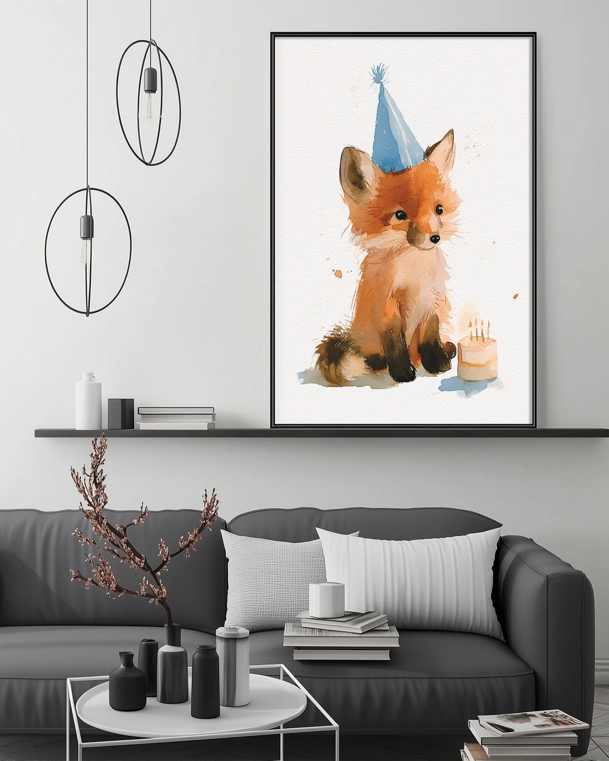 a cozy living room with a gray couch, a coffee table, and a framed watercolor painting of a fox wearing a birthday hat.