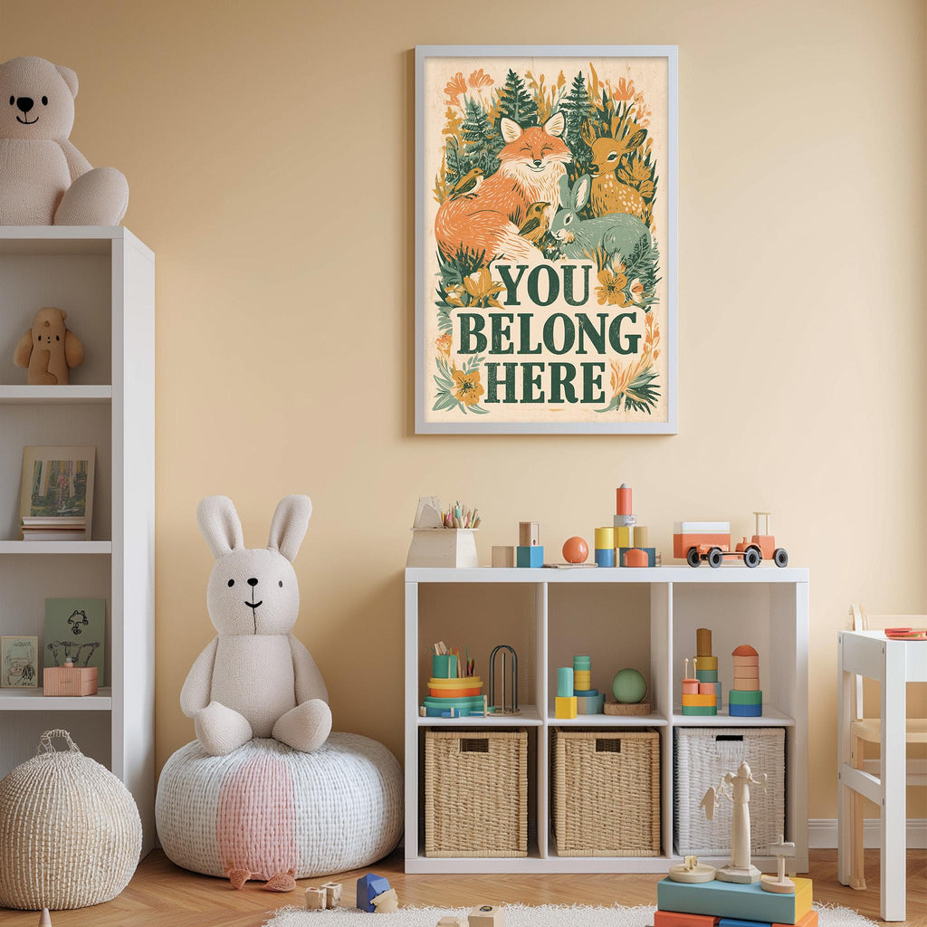 A child's bedroom with a white bookshelf, a stuffed rabbit, and a toy train. Above the bookshelf is a framed poster with the text "YOU BELONG HERE".