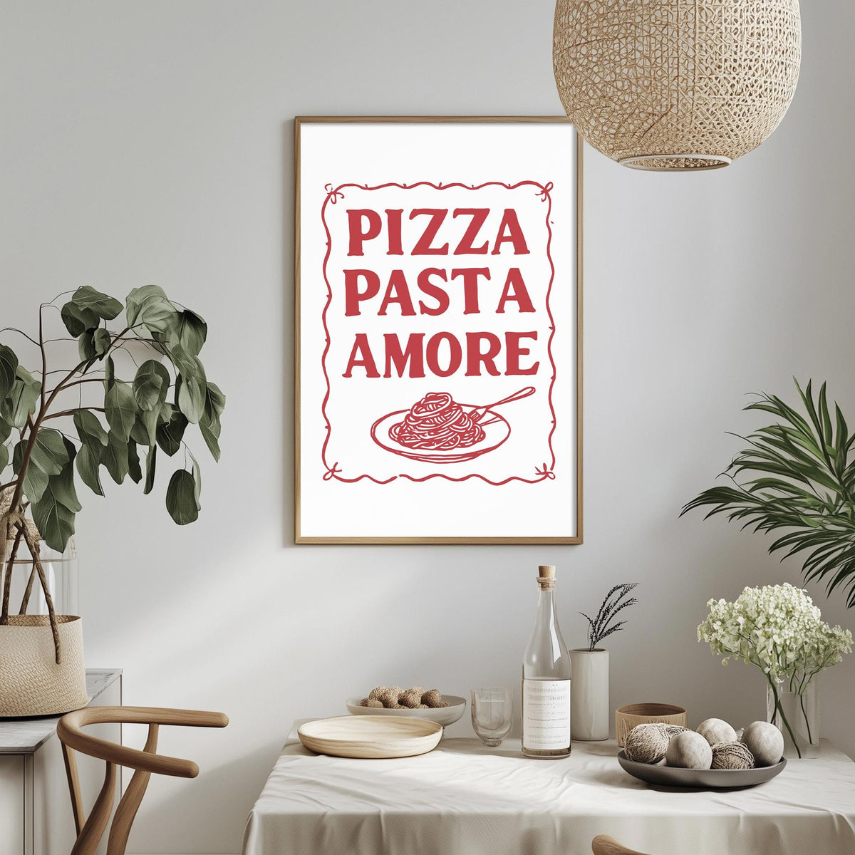 a framed poster with the text "PIZZA PASTA AMORE" hanging on a wall above a dining table with various items on it.