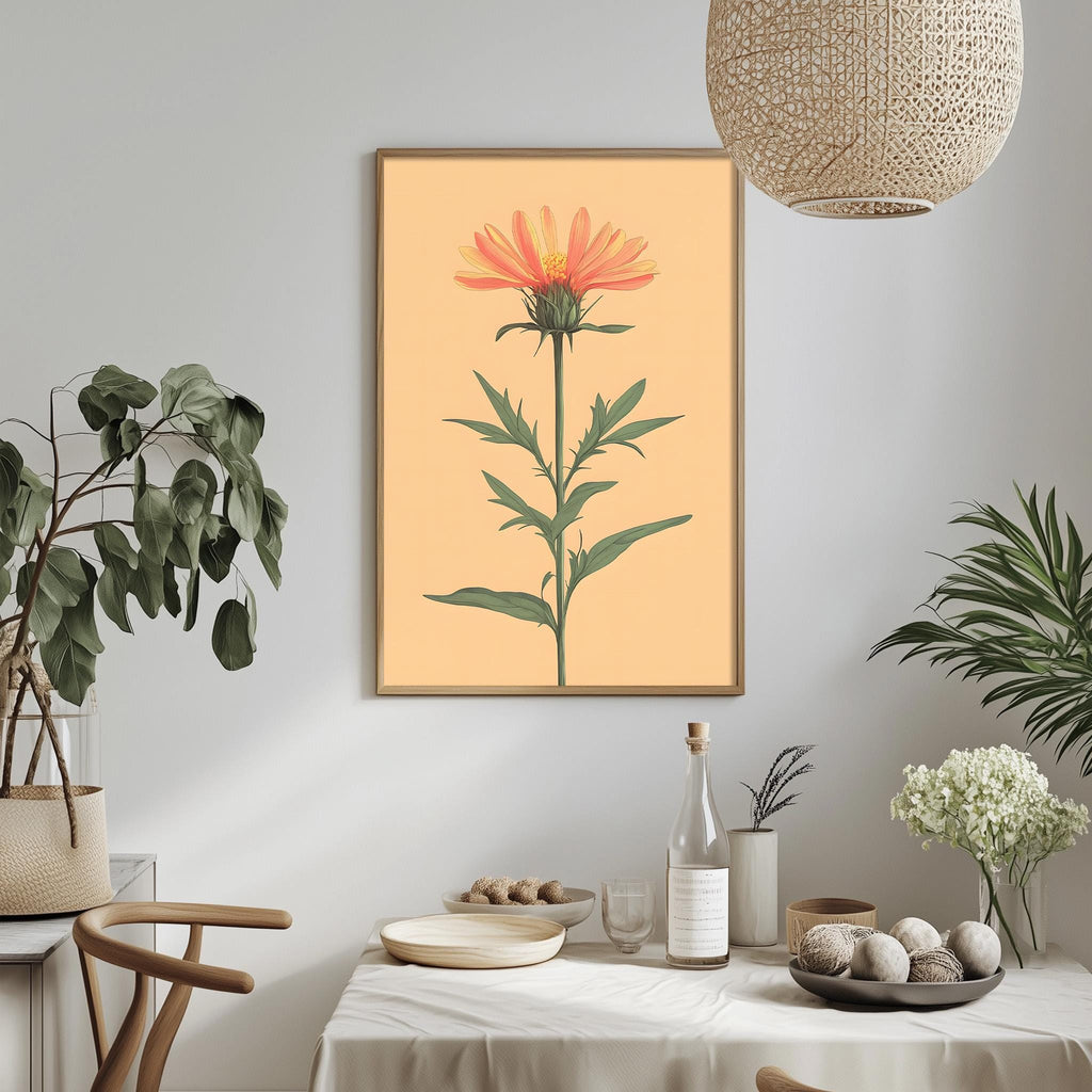 a dining table with a white tablecloth, a bowl of fruit, a bottle, and a vase with flowers. Above the table, there is a framed picture of a flower on the wall.