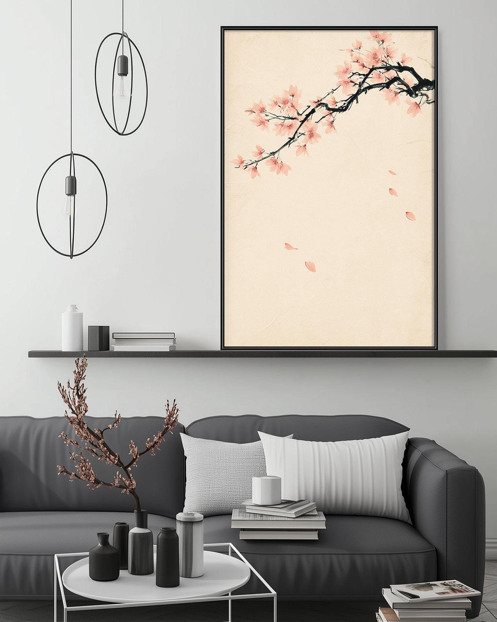 a modern living room with a gray sofa, a coffee table, and a large framed artwork depicting a cherry blossom tree with pink flowers.