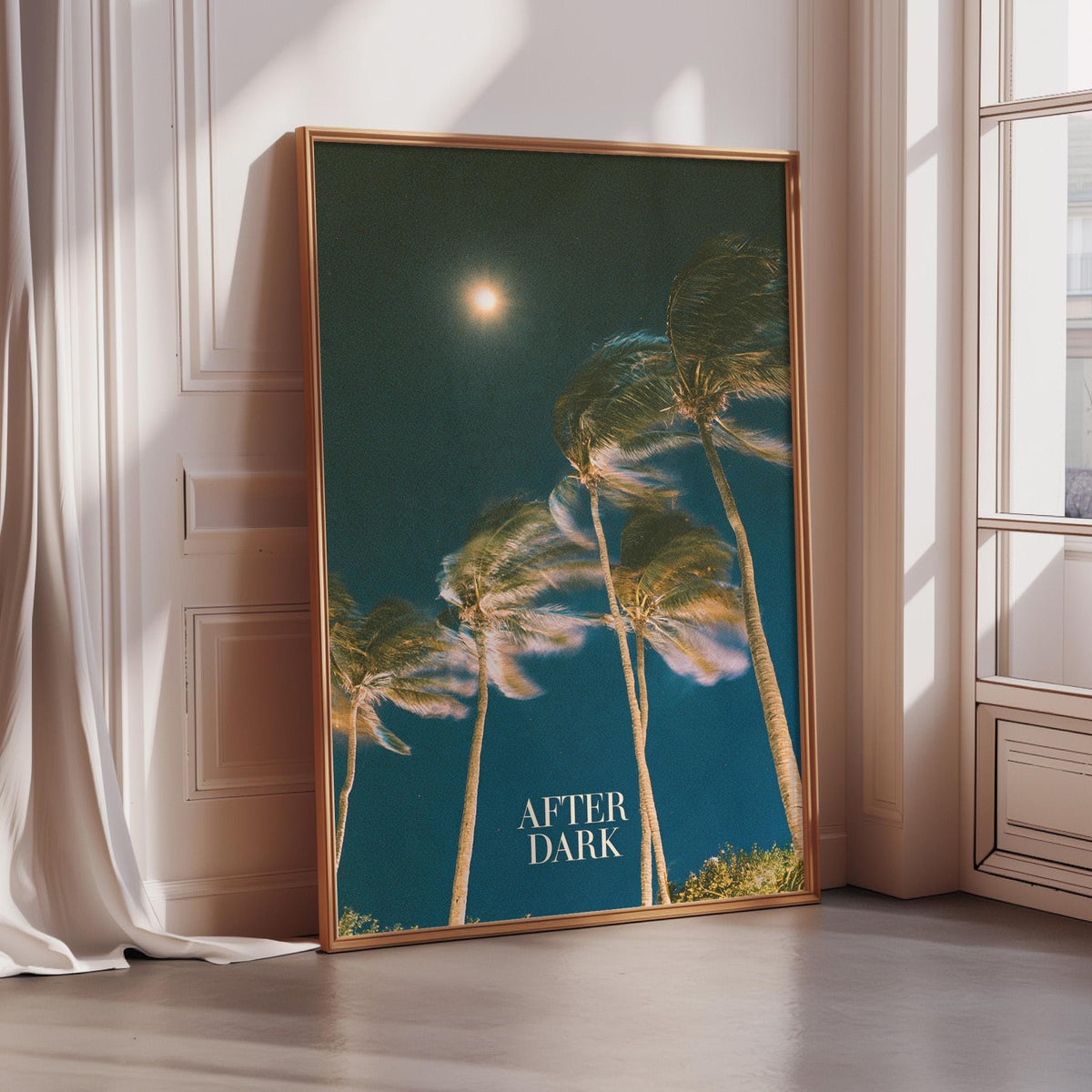 a framed poster of swaying palm trees against a dark blue sky with a full moon.
